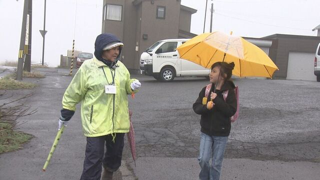 交差点に向かう金谷さんと近くに住む小学生
